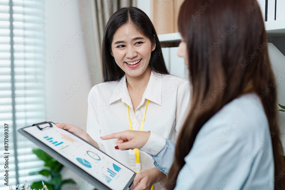 Professional Business Meeting with Colleagues Analyzing Financial Data on a Tablet in a Modern Office Setting Professional Business Meeting with Colleagues Analyzing Financial Data on a Tablet in a Modern Office Setting