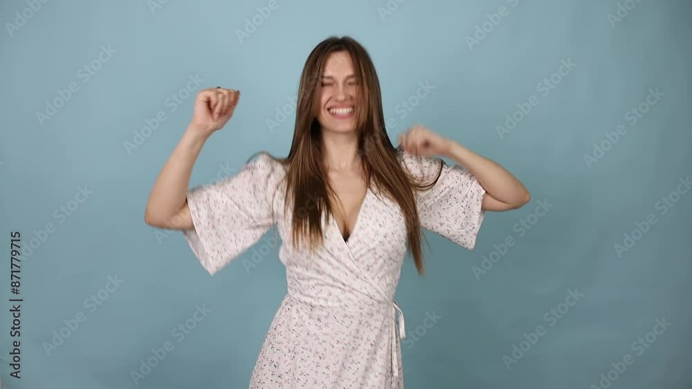Young Woman Dancing, In a Summer Light Dress, on a Blue Background. Slow Motion. Young Woman Dancing, In a Summer Light Dress, on a Blue Background. Slow Motion.