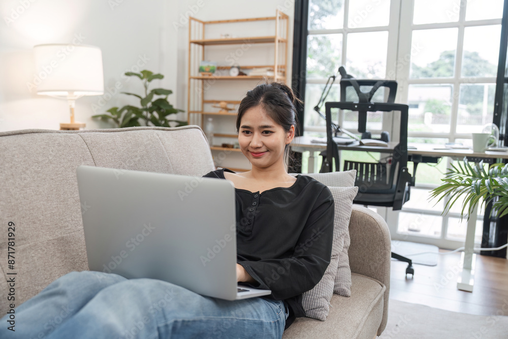Young Woman Studying Online at Home on Laptop, Relaxed Learning Environment, Modern Home Office Setup, Remote Education Concept Young Woman Studying Online at Home on Laptop, Relaxed Learning Environment, Modern Home Office Setup, Remote Education Concept