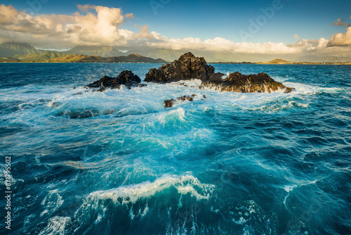 Aerial view of rocky shore with waves and blue water, BS Island, United States. photo