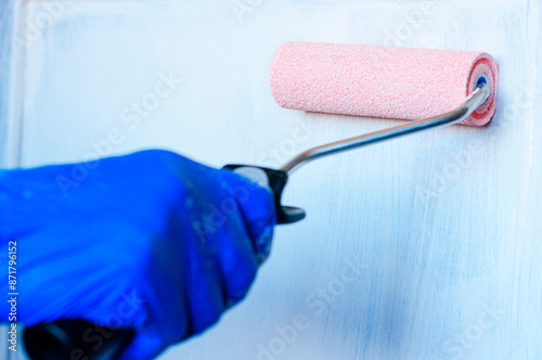 Painting an old piece of furniture white to renovate.