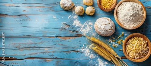 A blue wooden table displays compressed yeast near dough ingredients, with a perfect copy space image. photo