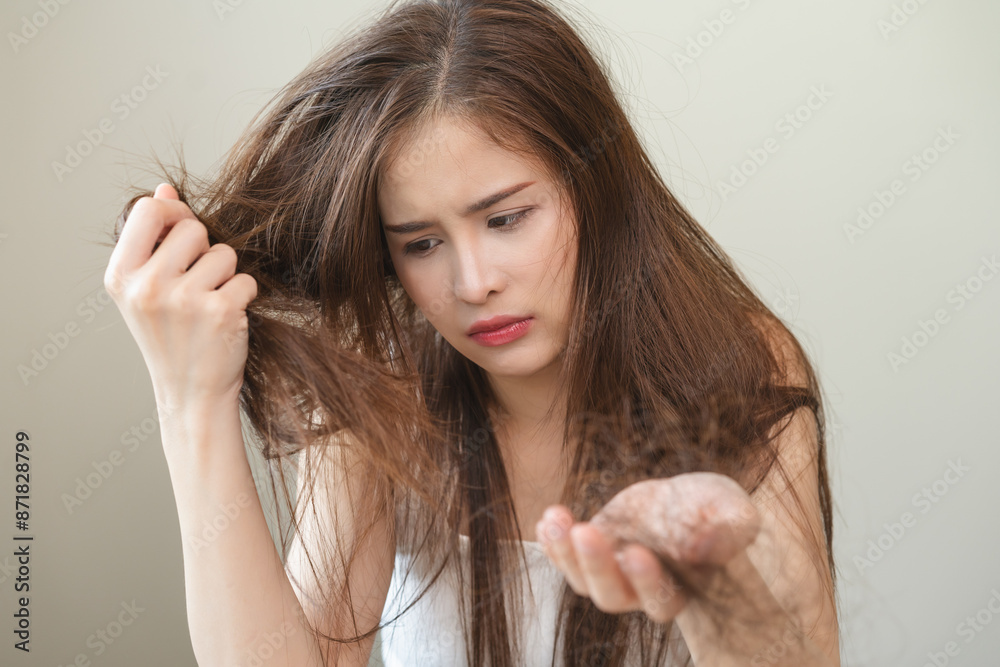 Serious, worried asian young woman, girl holding, show damaged loss hair, problem after brushing, hair fall out on hand. Health care of beauty treatment. Portrait isolated on background, copy space. Serious, worried asian young woman, girl holding, show damaged loss hair, problem after brushing, hair fall out on hand. Health care of beauty treatment. Portrait isolated on background, copy space.