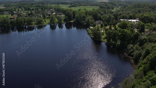 Aerial view of the small town of Birini Castle, located in a green park. The parish is surrounded by well-maintained paths, trees and open grass. Residential buildings and a lake photo