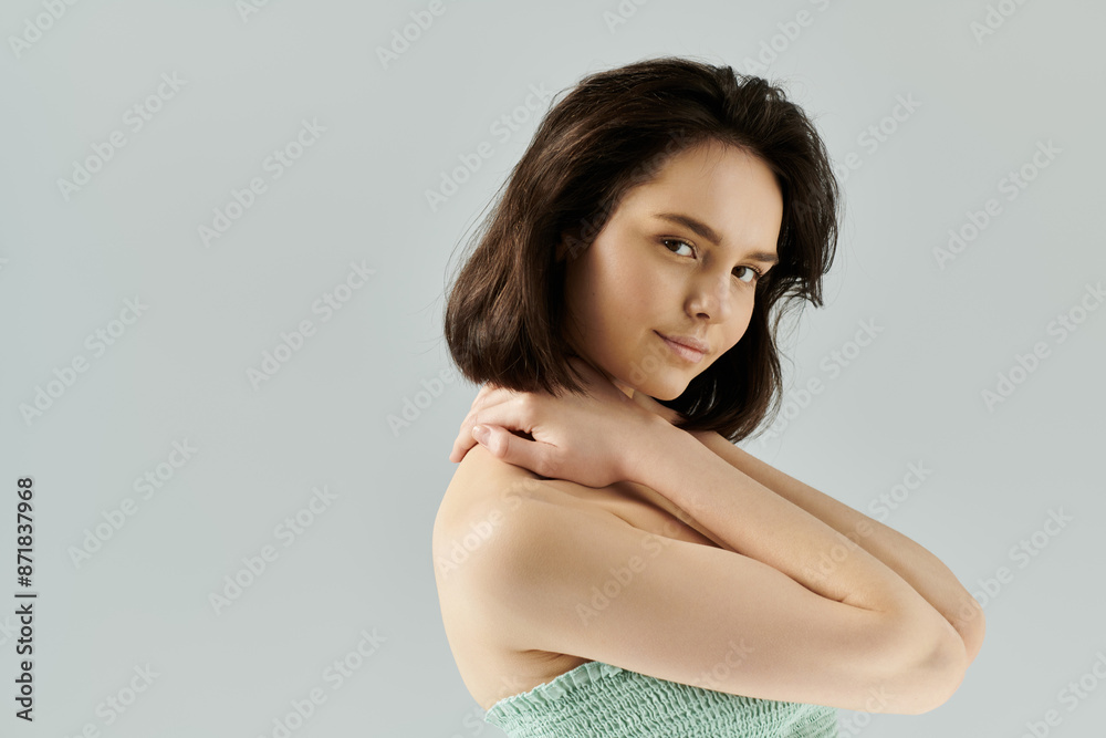 Fototapeta premium A portrait of a beautiful woman posing in a studio with soft lighting.