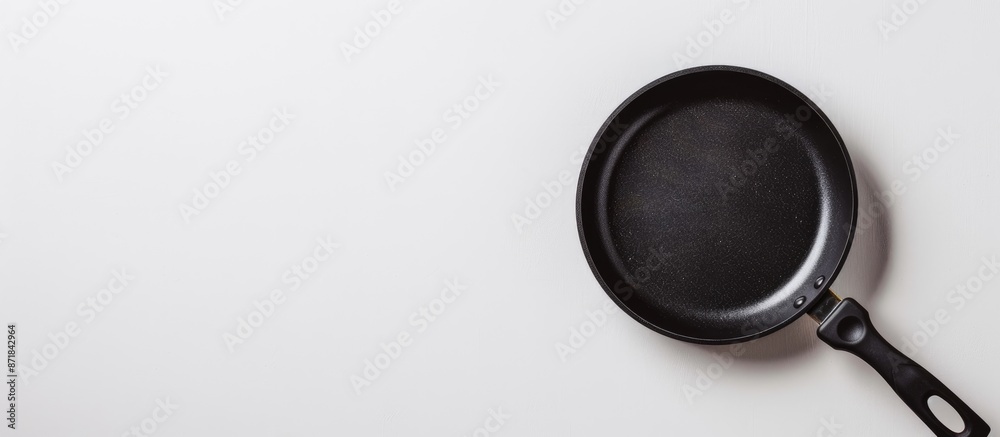 Close-up of frying pan on white background with copy space image. Close-up of frying pan on white background with copy space image.