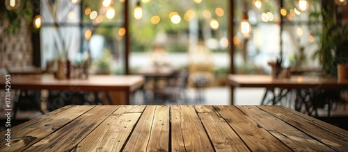 Brown wooden table with blur background at a cafe, perfect for product display montage with copy space image.