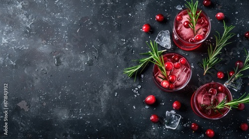 Christmas cocktail with cranberry and rosemary on a dark background Top view with space for text