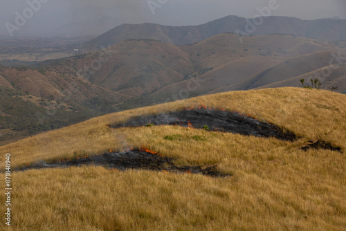 A fire starts in rural grasslands
