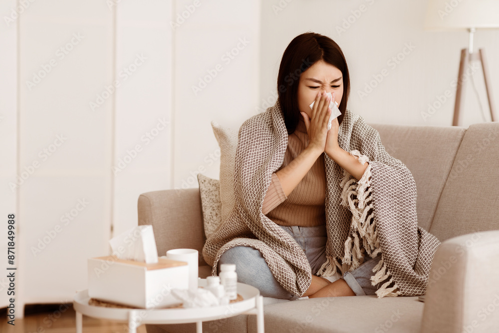 Seasonal Flu. Teen Girl Has Runny Nose at Home, Blowing her Nose into Paper Napkin, Copy Space