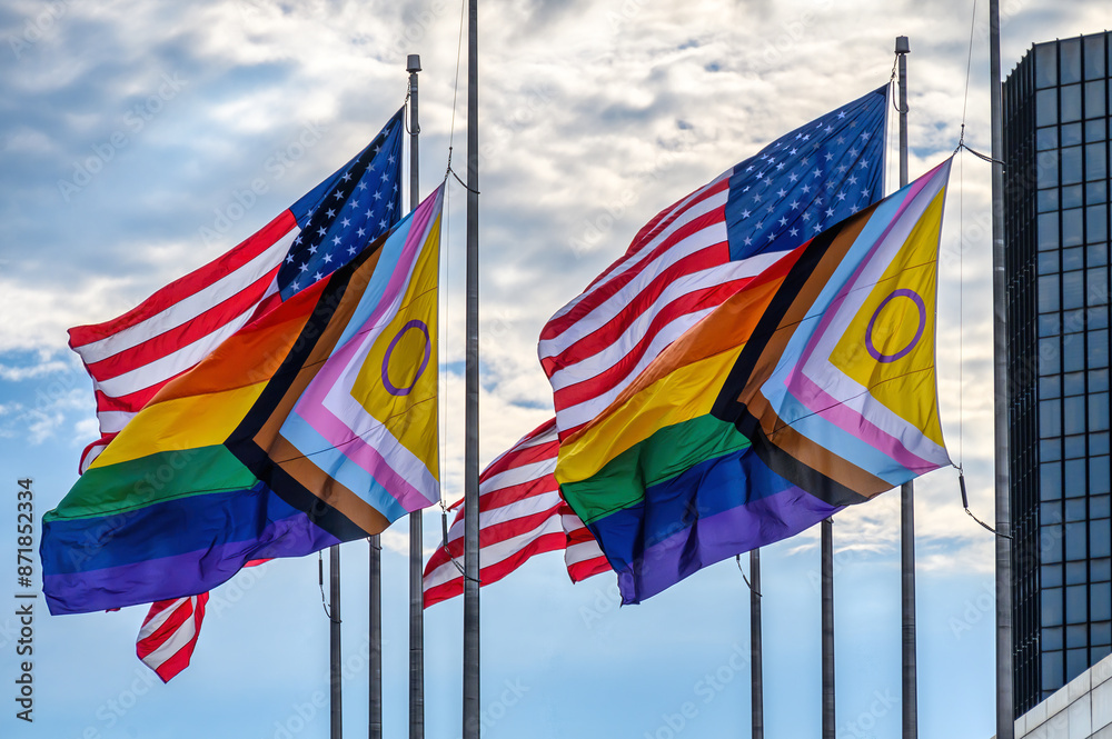American flags and LGBTQ rainbow flags flying together in the wind, Detroit, USA American flags and LGBTQ rainbow flags flying together in the wind, Detroit, USA
