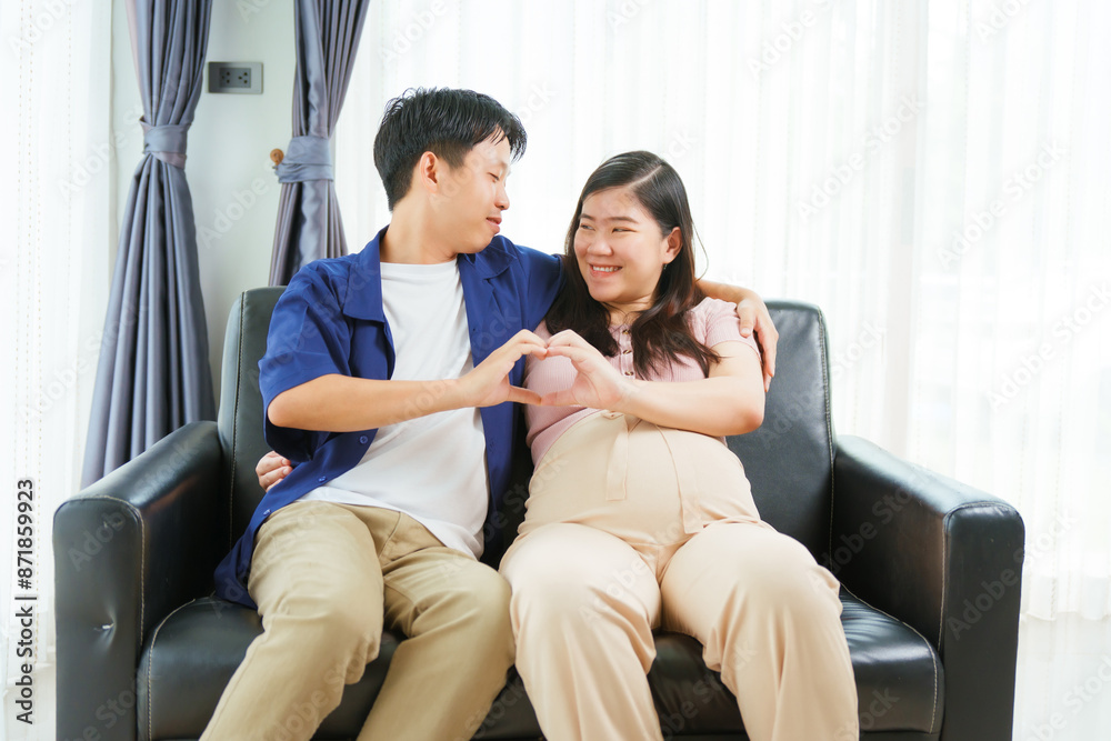 An Asian young husband gently embraces his pregnant wife at home, their love evident as they prepare for parenthood, cherishing the tender moments of expecting their first child together. An Asian young husband gently embraces his pregnant wife at home, their love evident as they prepare for parenthood, cherishing the tender moments of expecting their first child together.