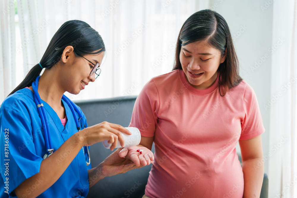 Asian female doctor and nurse consult on sofa with a pregnant woman, using ultrasound and stethoscope, addressing illnesses morning sickness, gestational diabetes, hypertension, ensuring her health. Asian female doctor and nurse consult on sofa with a pregnant woman, using ultrasound and stethoscope, addressing illnesses morning sickness, gestational diabetes, hypertension, ensuring her health.