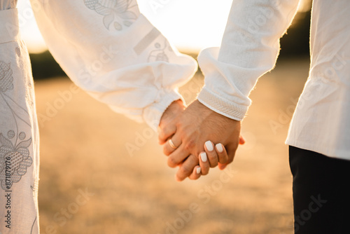 couple holding hands together, outdoor, close up