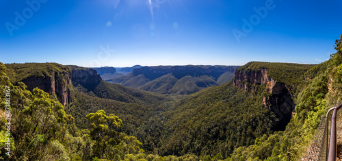 Photos Govetts Leap Lookout, a panoramic view of the Blue Mountains National Park in New South Wales, Australia, featuring a lush valley, rugged cliffs, and a clear blue sky