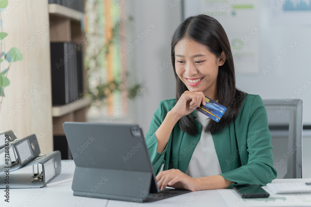 mage of a young Asian businesswoman holding a credit card. mage of a young Asian businesswoman holding a credit card.