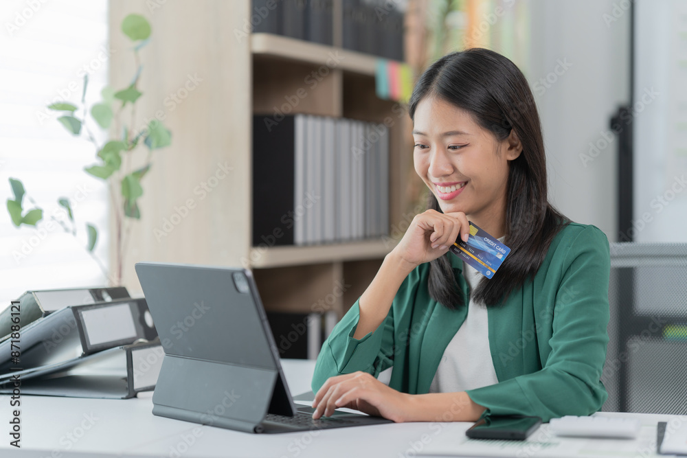 mage of a young Asian businesswoman holding a credit card. mage of a young Asian businesswoman holding a credit card.