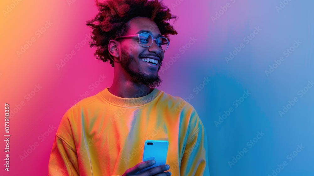 Vibrant Neon Lighting Portrait of Joyful Young Man with Smartphone