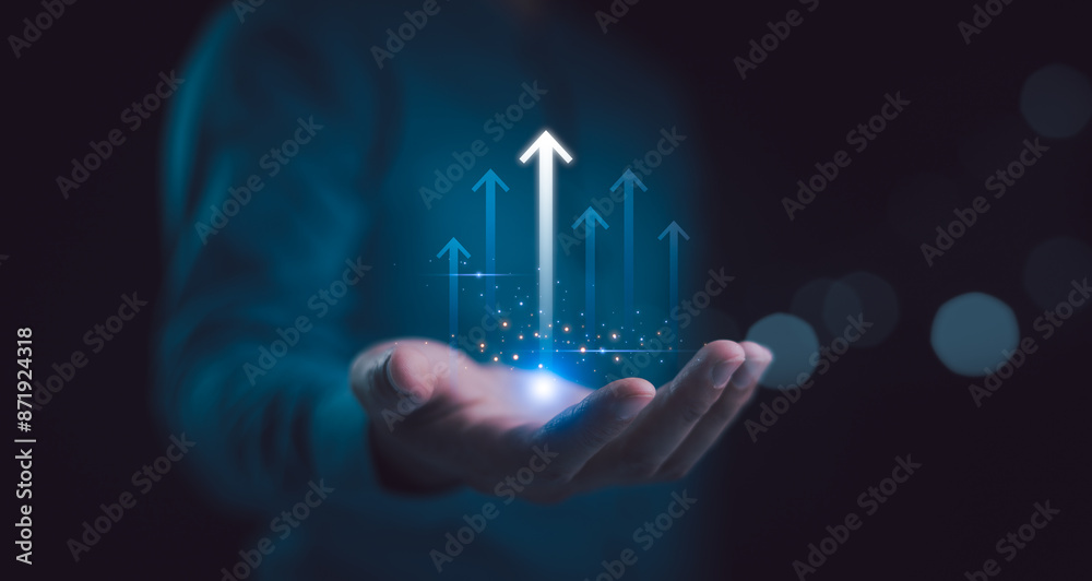 Hand holding growth business strategy arrow concept on success target improvement with increase development graph profit or economy investment income target and goal increase achievement.