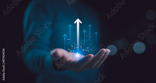 Obraz na płótnie Hand holding growth business strategy arrow concept on success target improvement with increase development graph profit or economy investment income target and goal increase achievement. w salonie