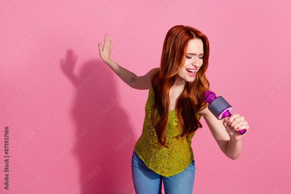 Portrait of nice young lady sing mic wear shiny top isolated on pink color background