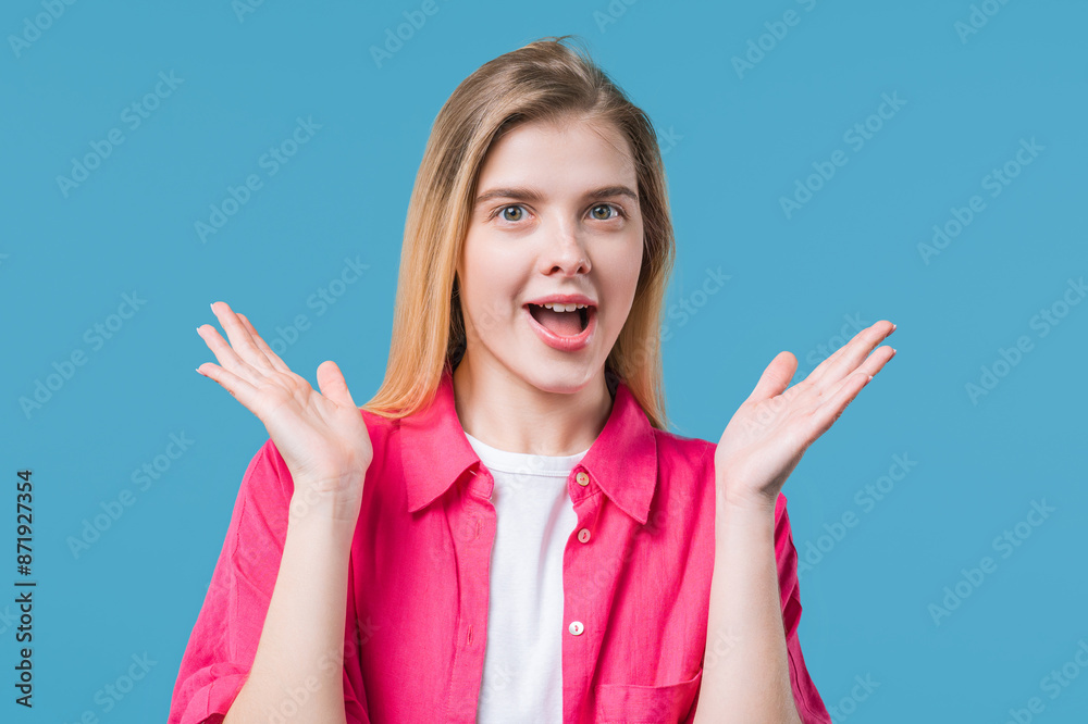 Amazed woman, she expresses WOW. Impressed lady on blue background. Great news. Amazed woman, she expresses WOW. Impressed lady on blue background. Great news.