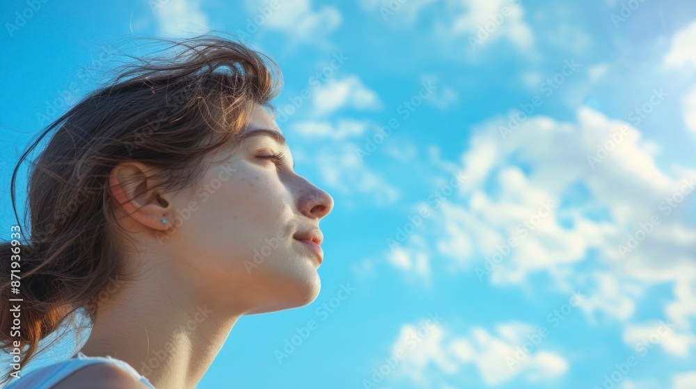 beautiful white woman with closed eyes looking up with a beautiful blue sky background beautiful white woman with closed eyes looking up with a beautiful blue sky background