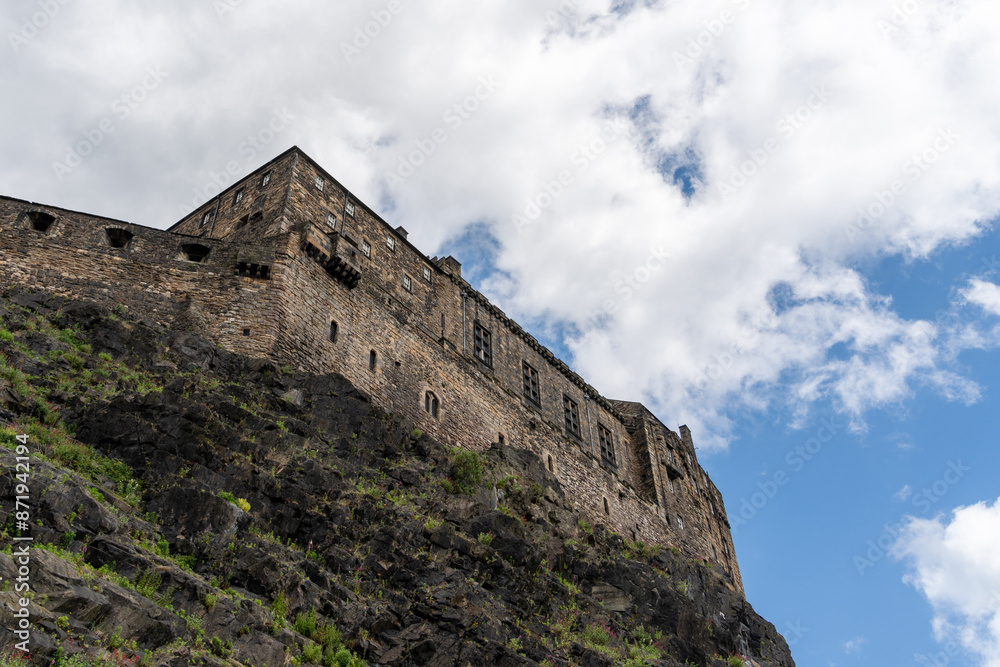 Scenic, dramatic view looking up at Edinburgh Castle, the popular tourist attraction in Edinburgh, Scotland, UK. Scenic, dramatic view looking up at Edinburgh Castle, the popular tourist attraction in Edinburgh, Scotland, UK.