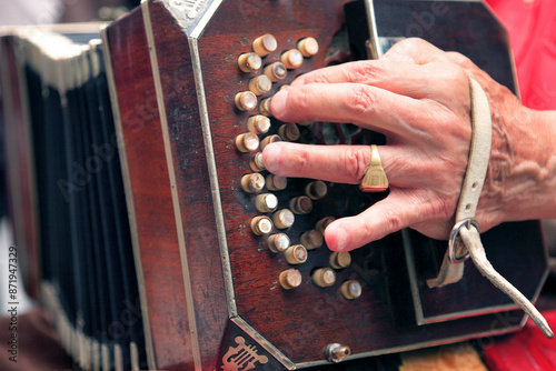 Photos Old musician hand playing Tango on a a bandoneon