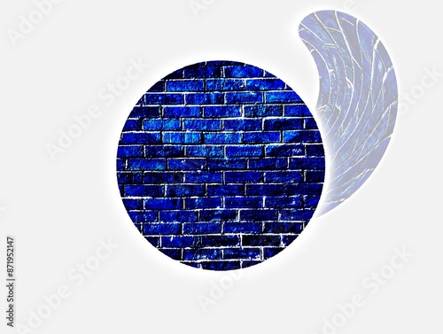 The white background in the image is a circle within a circle with an image of blue bricks arranged in a circle and a faint silver ripple on the right. This image has been used as an illustration in v