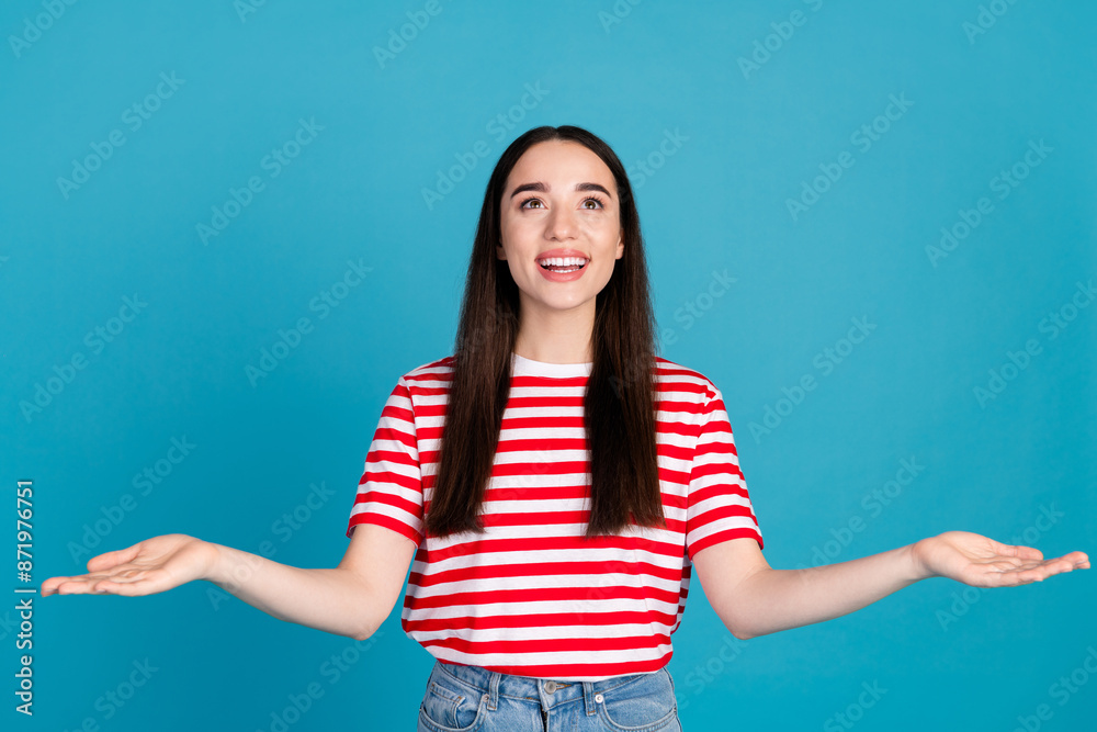Photo of cheerful pretty lady dressed red t-shirt comparing arms looking empty space isolated blue color background Photo of cheerful pretty lady dressed red t-shirt comparing arms looking empty space isolated blue color background