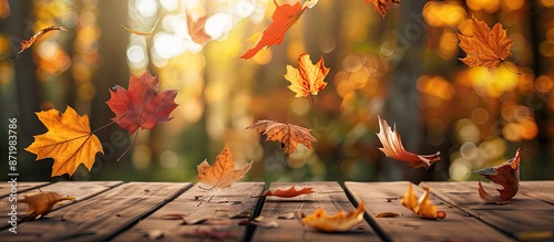 Autumn maple leaves on a wooden table create a falling leaves natural background with copy space image. photo