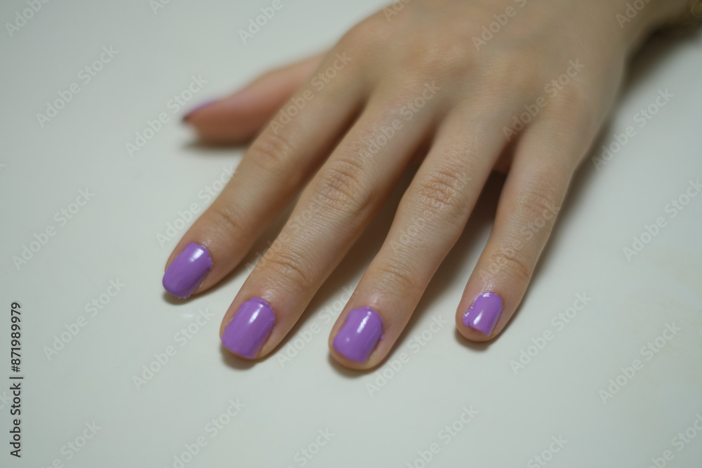 Close-up of hand nails. Close-up of hand nails with purple nail polish. Personal care Beauty and elegance.