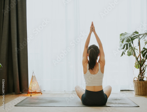 Asian girl doing yoga at home in a white background
