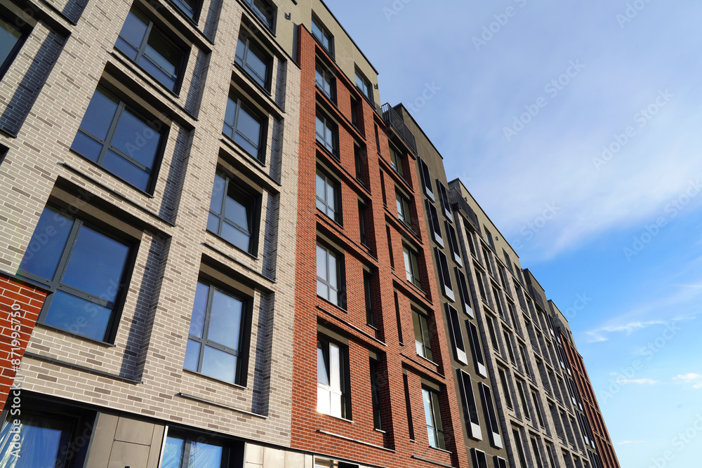 Facade building. Modern building and houses against blue sky. Colorful buildings with glass windows, balconies. Buildings architecture. Skyline Skyscrapers. Urban Residential building exterior. Facade building. Modern building and houses against blue sky. Colorful buildings with glass windows, balconies. Buildings architecture. Skyline Skyscrapers. Urban Residential building exterior.
