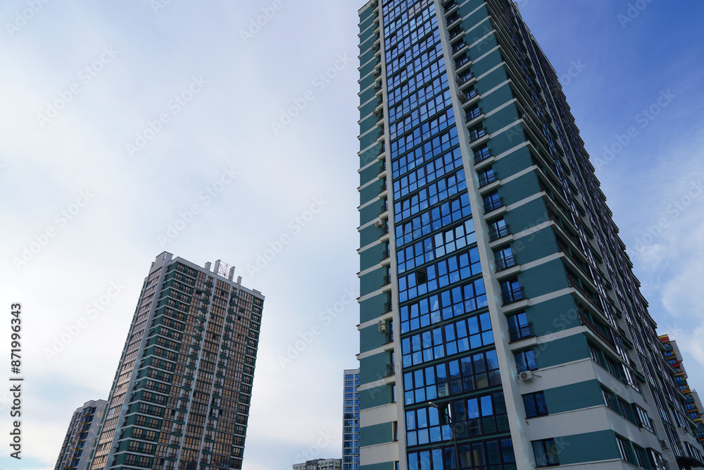 Facade building on blue sky background. Modern building, houses. Colorful buildings with glass windows, balconies. Buildings architecture. Skyline Skyscrapers. Urban Residential building exterior. Facade building on blue sky background. Modern building, houses. Colorful buildings with glass windows, balconies. Buildings architecture. Skyline Skyscrapers. Urban Residential building exterior.