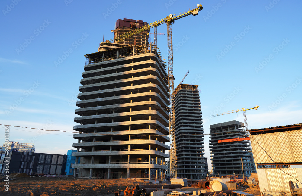 Fototapeta premium Construction site. Construction of Skyscrapers. Tower Crane on formworks. Construction of Multi Storey Residential Building. Tower Cranes on Residential buildings Construction. Housing built.