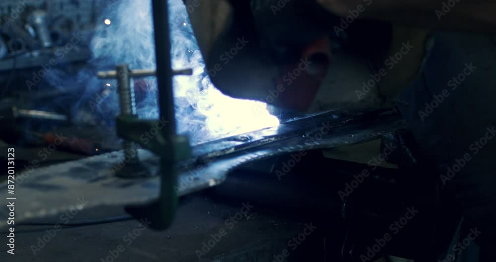 Super slow motion close up of welder blacksmith is welding metal steel with industrial tool with flying sparks in workshop at 1000 fps. Super slow motion close up of welder blacksmith is welding metal steel with industrial tool with flying sparks in workshop at 1000 fps.