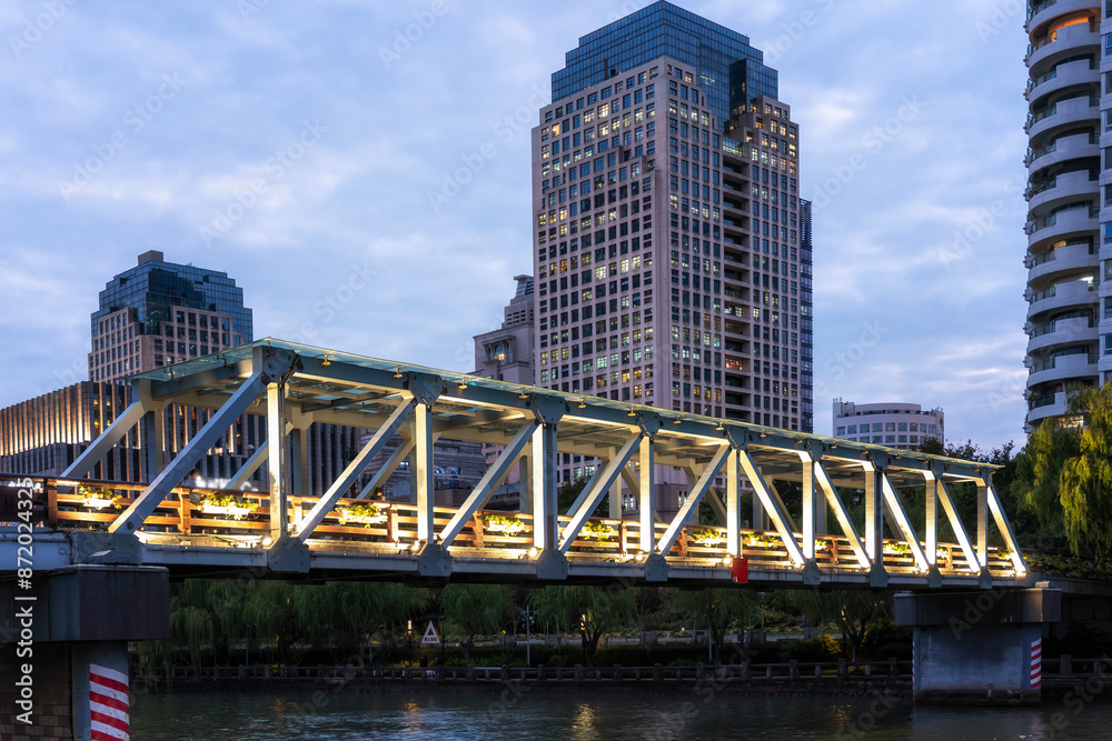 Naklejka premium Illuminated Bridge and Skyscrapers at Dusk