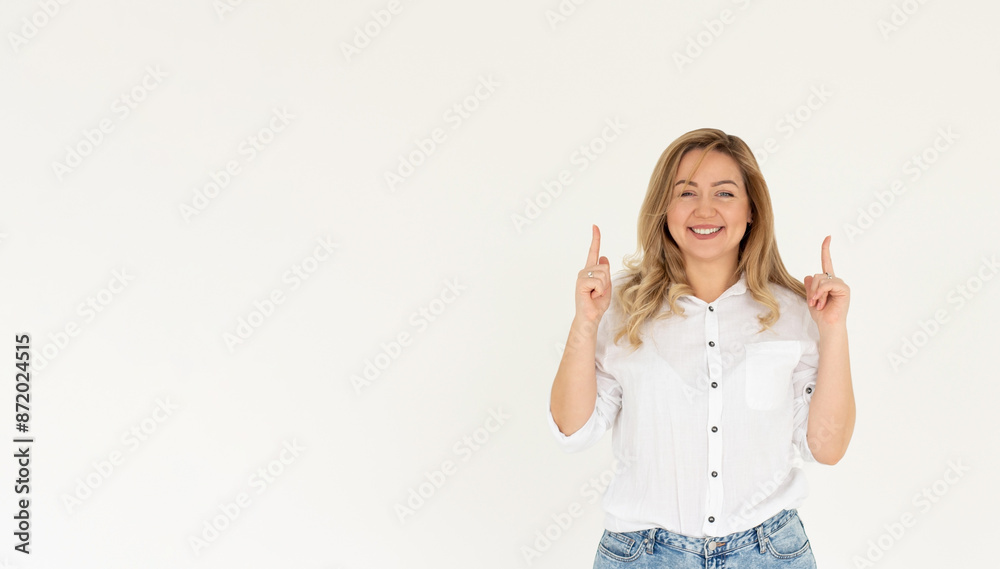 Smiling woman pointing finger up over white background Smiling woman pointing finger up over white background