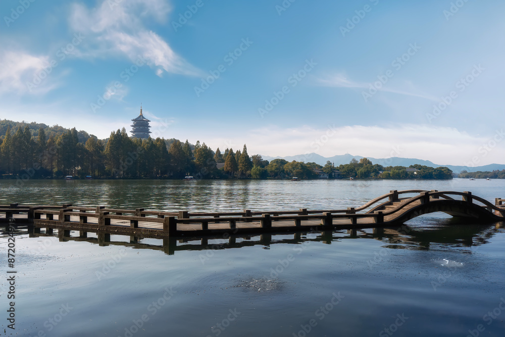 Naklejka premium Serene Lake with Traditional Pavilion and Wooden Bridge