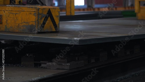 Heavy metal plate being lifted with a magnet photo