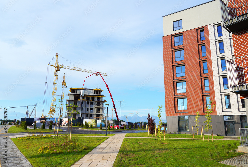 Residential Construction. Housing built. Tower crane formworks. Pouring concrete use сoncrete pump ready-mixed. Concrete Pump Machinery on Formworks. Building construction. Modern Urbanisation build. Residential Construction. Housing built. Tower crane formworks. Pouring concrete use сoncrete pump ready-mixed. Concrete Pump Machinery on Formworks. Building construction. Modern Urbanisation build.