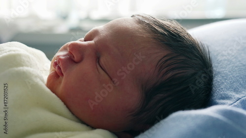 Newborn Baby Sleeping Peacefully on a Blue Pillow, Capturing the Serene and Innocent Moment of Rest in a Soft, Natural Light Setting