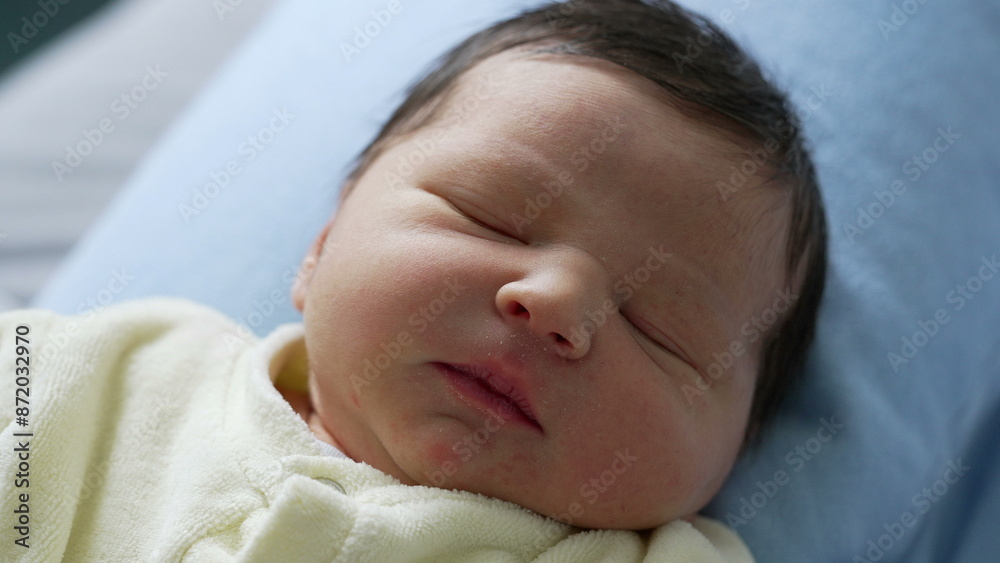 Newborn baby sleeping with a peaceful expression, resting on a blue pillow. delicate features and serene atmosphere, innocence and tranquility of newborn life Newborn baby sleeping with a peaceful expression, resting on a blue pillow. delicate features and serene atmosphere, innocence and tranquility of newborn life