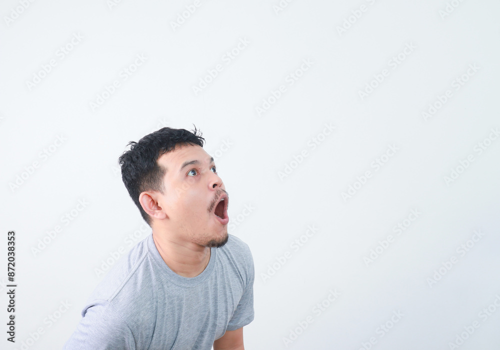 Surprised shocked face asian man isolated on white background for advertisement. Surprised shocked face asian man isolated on white background for advertisement.
