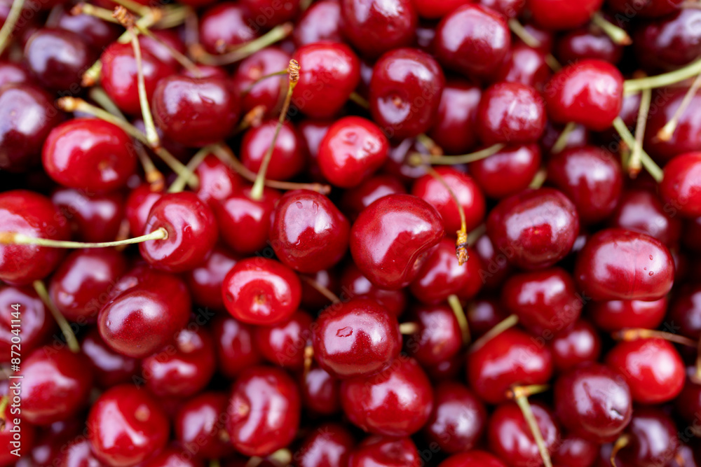 Cherry background, texture. Lots of cherries, top view. Cherry for background and screensaver. Cherry berry wallpaper, background. Bunch of red cherries. Cherry background, texture. Lots of cherries, top view. Cherry for background and screensaver. Cherry berry wallpaper, background. Bunch of red cherries.