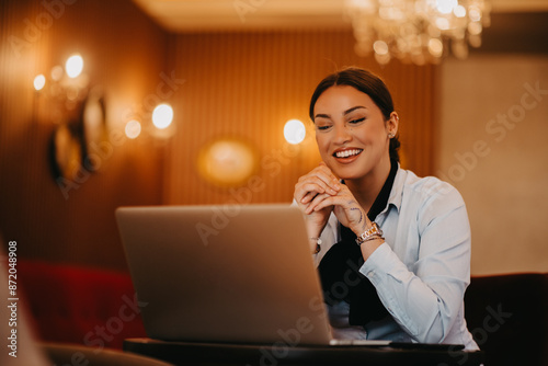Radiant Latina businesswoman confidently leads business meeting over coffee.