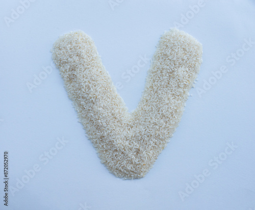 White Rice Grain Alphabet Letter V photo