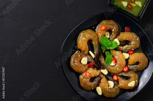 Pickled shrimp in soy sauce, chilli and garlic on stone background, korean food photo